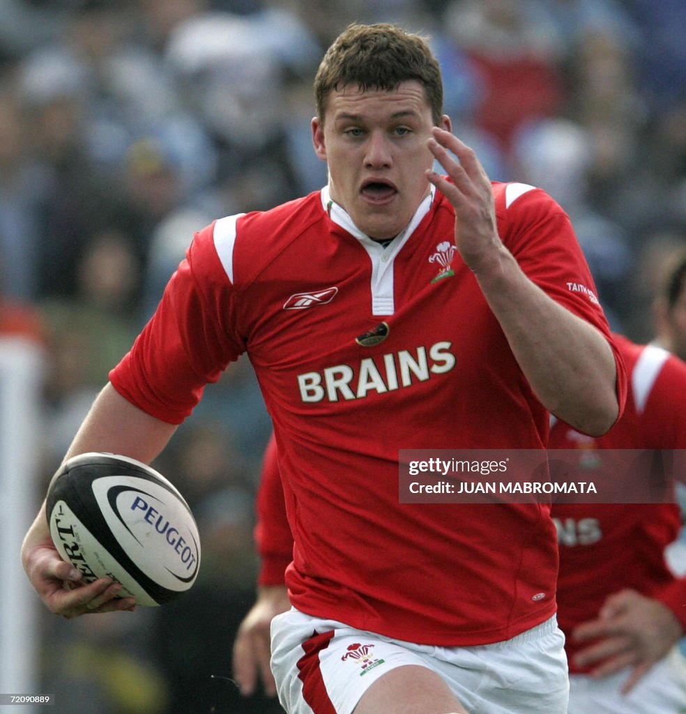 Ian Evans from Wales, runs to score afte