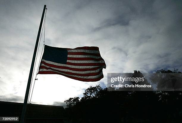 Flag flies at half mast outside a post office October 5, 2006 in Bart Township, Pennsylvania. Funerals for four of the five girls killed by a gunman...
