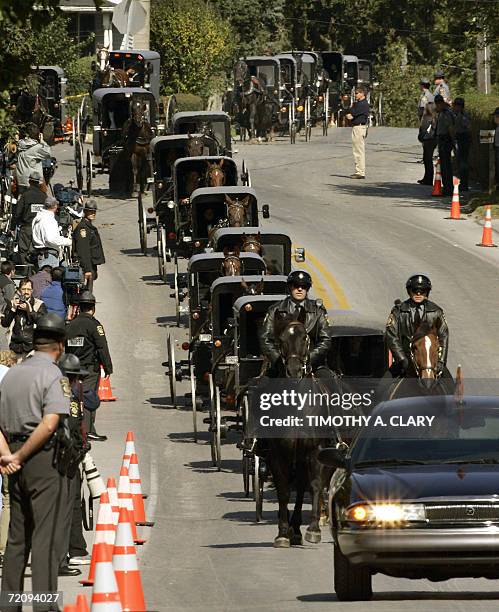 Nickel Mines, UNITED STATES: A funeral procession for one of the victims of the Amish school makes its way through the town of Nickel Mines,...