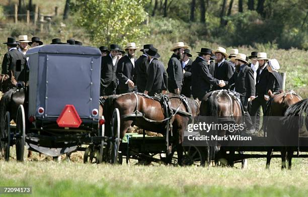 Members of the Amish community arrive at the Miller farm before the funeral for eight-year-old Mary Liz Miller and her sister seven-year-old Lena...