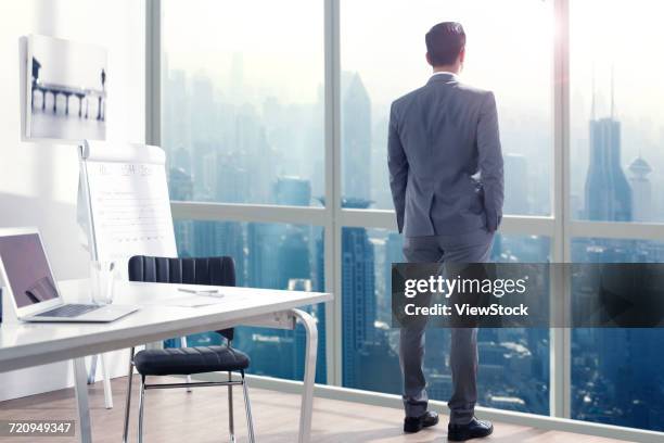 businessman standing in office - ビジネスフォーマル ストックフォトと画像