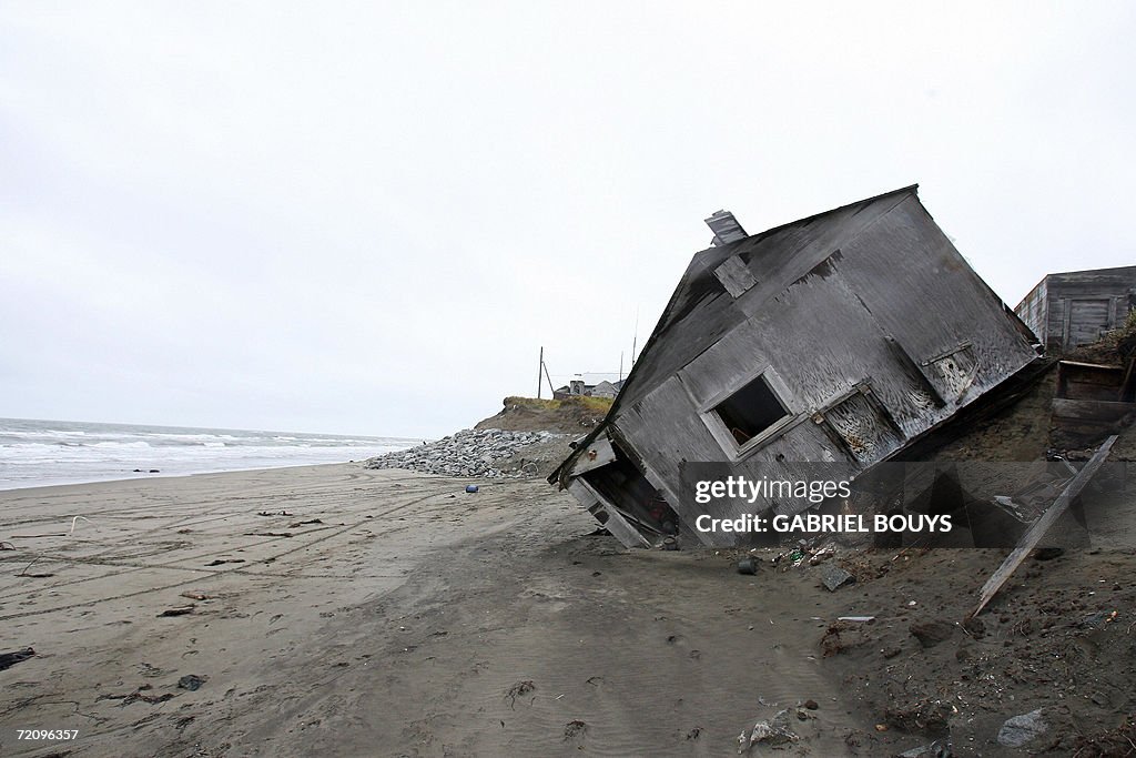 A home destroyed by beach erosion lies o