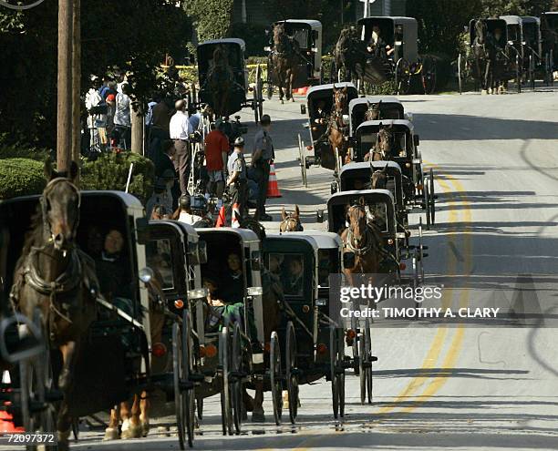Nickel Mines, UNITED STATES: The funeral procession of Marian Fisher, age 13, a victim of the Amish school shooting makes its way through the town of...
