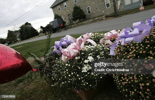 Collection of flowers, notes, and other tokens of sympathy lie on the side of Mine Road October 5, 2006 in Nickel Mines, Pennsylvania. On Monday a...