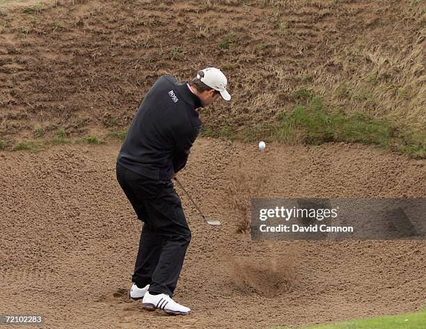 Bradley Dredge of Wales plays his second shot from a deep bunker beside the green on the 16th hole during the second round of the Alfred Dunhill...