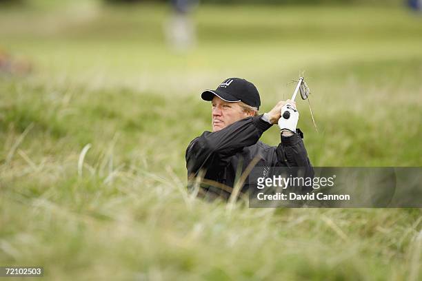 Michael Lynagh of Australia hits his second shot at the 2nd hole during the second round of the Alfred Dunhill Links Championship at Carnoustie, on...