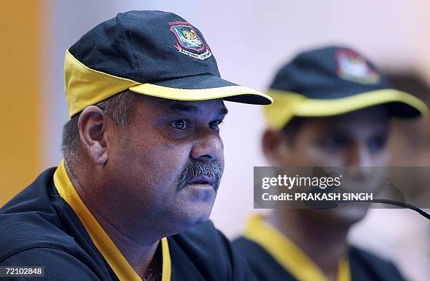 Bangladesh cricket team coach Davenell Whatmore addresses media representatives as team captain Habibul Basher looks on during a press conference at...