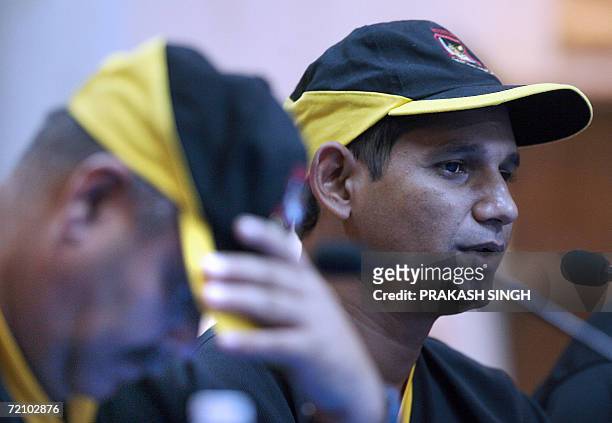 Bangladesh cricket team captain Habibul Basher addresses media representatives as coach Davenell Whatmore looks on during a press conference at the...