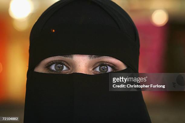 Muslim woman wearing a Niqab poses inside an Asian fashion shop in the British northern town of Blackburn, the constituency of Member of Parliament...