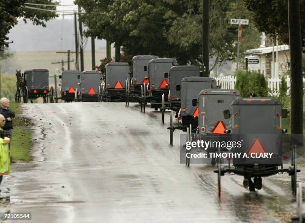 Nickel Mines, UNITED STATES: The funeral procession of Anna Mae Stoltzfus, age 12, a victim of the Amish school shooting makes its way through the...