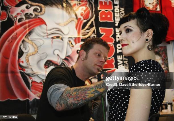 Tattoo artist works at the second British international tattoo event on October 6, 2006 at The Old Truman Brewery in Brick Lane, London England. The...