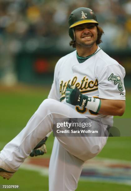 Nick Swisher of the Oakland Athletics reacts to striking out against the Minnesota Twins during game three of the American League Division Series at...