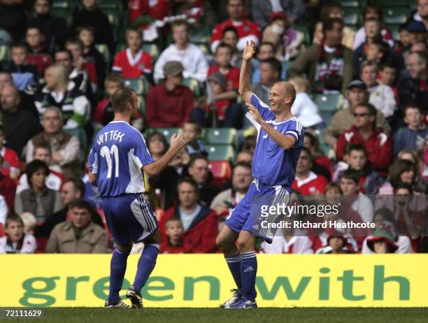Miroslav Karhan of Slovakia celebrates scoring the 4th goal with Robert Vittek during the EURO 2008 Group D qualifying match between Wales and...
