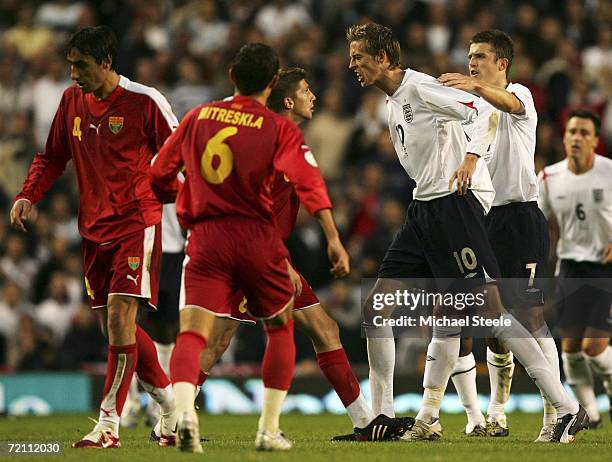 Peter Crouch of England confronts Velice Sumolikoski of Macedonia during the Euro 2008 Qualifying match between England and Macedonia at Old Trafford...