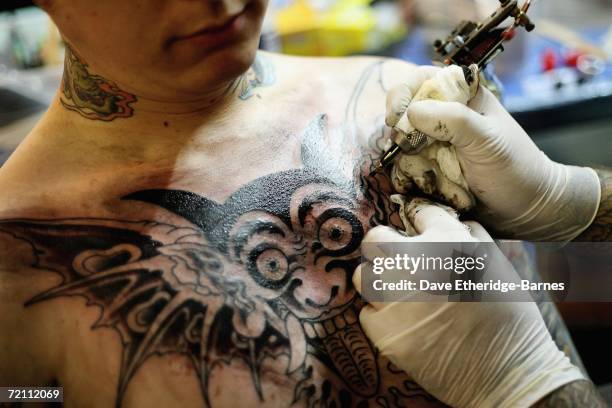 Tattoo artist works during day two of the second British international tattoo event on October 7, 2006 at The Old Truman Brewery in Brick Lane,...