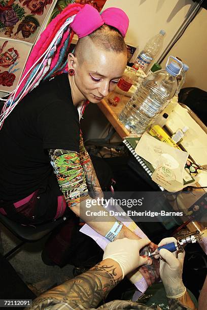 Tattoo artist works during day two of the second British international tattoo event on October 7, 2006 at The Old Truman Brewery in Brick Lane,...