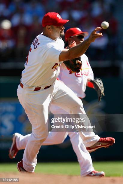 Infielder Albert Pujols of the St. Louis Cardinals attempts to throw out a San Diego Padres base runner during Game Three of the National League...