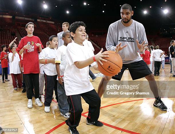 Tim Duncan of the San Antonio Spurs works with kids at a NBA Cares / Special Olympics clinic during the NBA Europe Live Tour presented by EA Sports...
