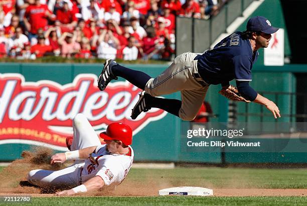 Infielder Todd Walker of the San Diego Padres throws to first base over Chris Duncan of the St. Louis Cardinals to complete a double play during the...