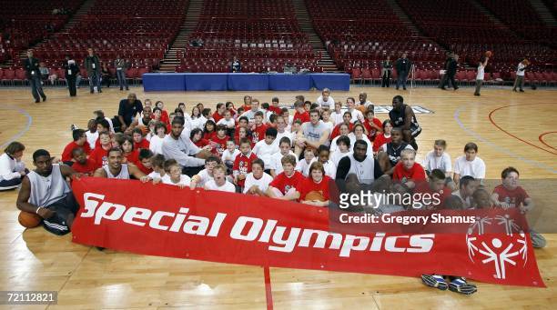 Members of the San Antonio Spurs pose with kids after the NBA Cares / Special Olympics clinic during the NBA Europe Live Tour presented by EA Sports...