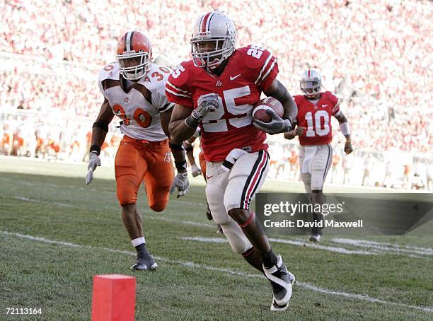 Antonio Pittman of the Ohio State Buckeyes scores a touchdown as he is chased by Erique Dozier of the Bowling Green Falcons while Buckeyes...