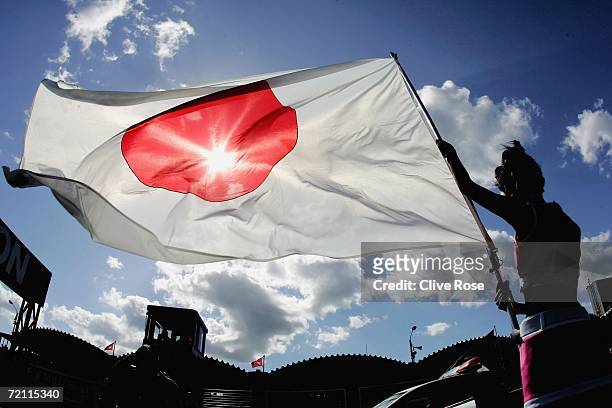 Grid girl holds the Japanese flag prior to the start of the Japanese F1 Grand Prix at the Suzuka Circuit on October 8, 2006 in Suzuka, Japan.