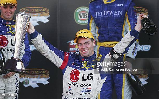 Craig Lowndes of Team Betta Electrical holds the Peter Brock Trophy aloft after winning the V8 Supercars Bathurst 1000 at the Mount Panorama Circuit...