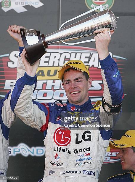 Craig Lowndes of Team Betta Electrical holds the Peter Brock Trophy aloft after winning the V8 Supercars Bathurst 1000 at the Mount Panorama Circuit...