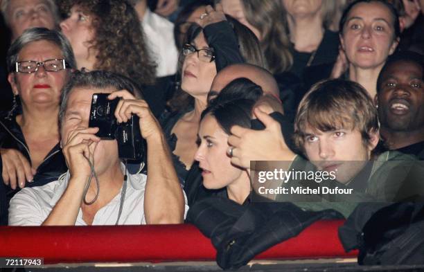 Photographer Mario Testino, actress Demi Moore and actor Ashton Kutcher attend the Jean Paul Gaultier party in Olympia as part of Paris Fashion Week...