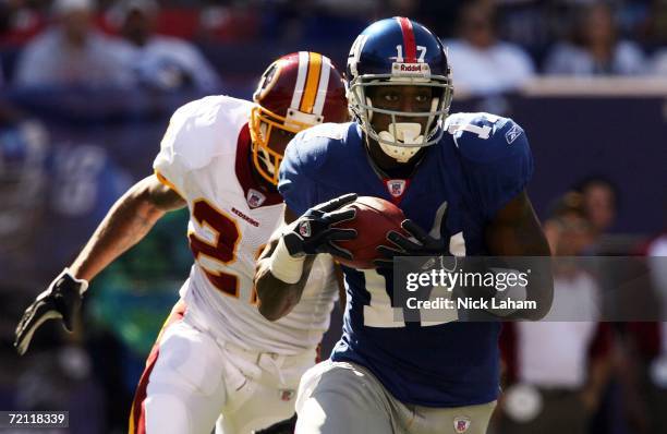 Plaxico Burress of the New York Giants runs for a 46-yard gain in front of Sean Taylor of the Washington Redskins on October 8, 2006 at Giants...