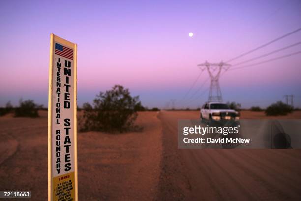 An unmarked US Customs and Border Protection border patrol vehicle drives along US-Mexico border where no fence divides the US from Mexico before...