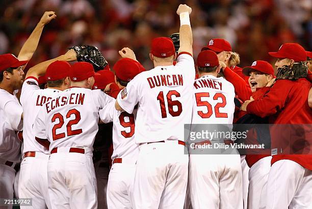 The St. Louis Cardinals celebrate on the field after defeating the San Diego Padres in Game Four of the National League Division Series at Busch...