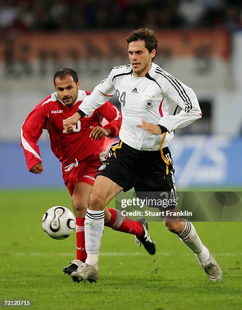 George Demetradze of Georgia challenges Manuel Friedrich of Germany during the friendly match between Germany and Georgia at the Ostsee Stadium on...