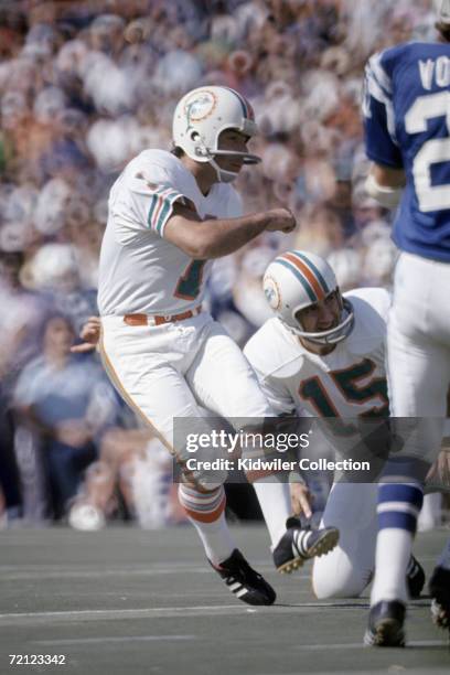 Placekicker Garo Yepremian, of the Miami Dolphins, watches the ball along with holder Earl Morrall during a game on November 11, 1973 against the...