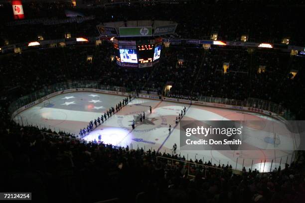 Palyerts line up for the singing of the National Anthem prior to a game between the San Jose Sharks and the St. Louis Blues on October 5, 2006 at the...