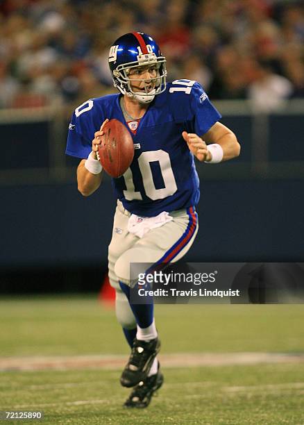Quarterback Eli Manning of the New York Giants scrambles out of the pocket against the Indianapolis Colts during their game on September 10, 2006 at...