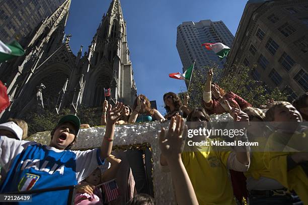 Crowd on a float cheers in celebration of Columbus Day while being driven down Fifth Avenue during the Columbus Day Parade October 9, 2006 in New...