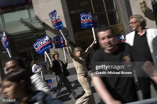 Supporters for New York State Attorney General candidate Andrew Cuomo follow him from the sidewalk as he marches down Fifth Avenue during the...