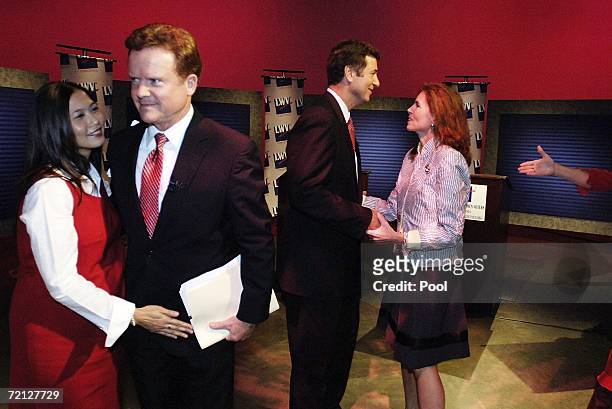 Incumbent U.S. Sen. George Allen and challenger, former Navy Secretary Jim Webb , are greeted by their wives Hong Webb and Susan Allen , after a...