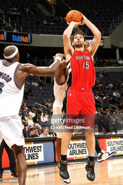 Jorge Garbajosa of the Toronto Raptors shoots against Brendan Haywood of the Washington Wizards on October 9, 2006 at the Verizon Center in...