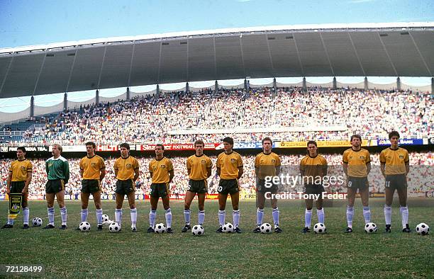 1980s: The Socceroos stand and sing the National Anthem before the match played between Australia and Argentina held at the Sydney Football Stadium,...