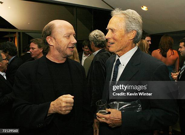 Writer Paul Haggis and actor/director Clint Eastwood talk at the afterparty for the premiere of Paramount's "Flags Of Our Fathers" at the Academy of...