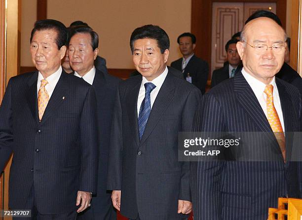 South Korean President Roh Moo-Hyun walks into a room with his predecessors Kim Dae-Jung , Kim Young-Sam and Chun Doo-Hwan before their luncheon to...