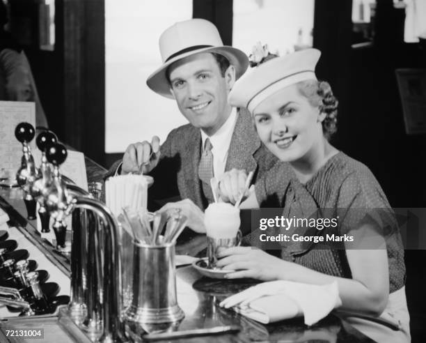 man and woman in fancy hat drinking ice cream soda (b&w), portrait - vintage restaurant stock pictures, royalty-free photos & images