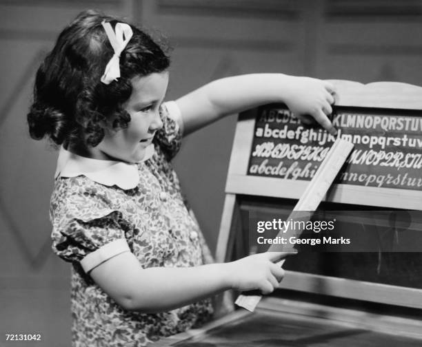 girl (4-5) learning alphabet (b&w) - girl vintage dress stock pictures, royalty-free photos & images