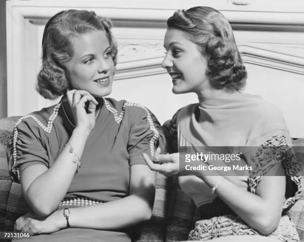 two young women talking in living room (b&w) - vintage women stock pictures, royalty-free photos & images