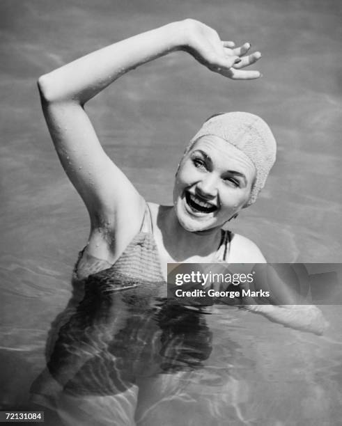 woman waving in pool (b&w),, elevated view - swimming cap stock pictures, royalty-free photos & images