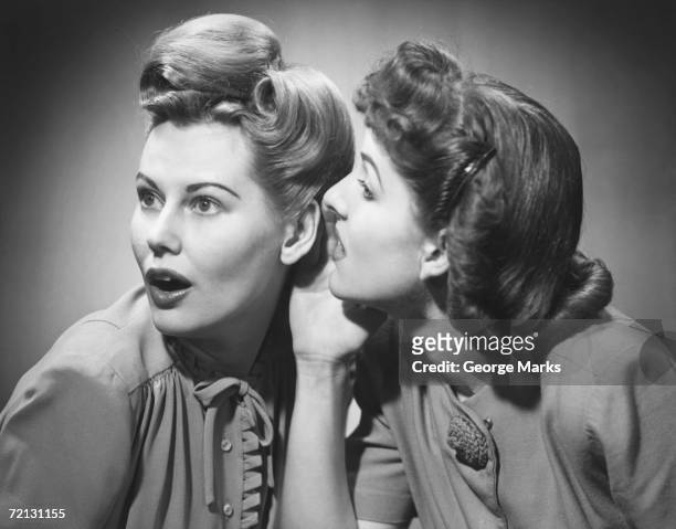 two women gossiping in studio (b&w) - 50s stockfoto's en -beelden