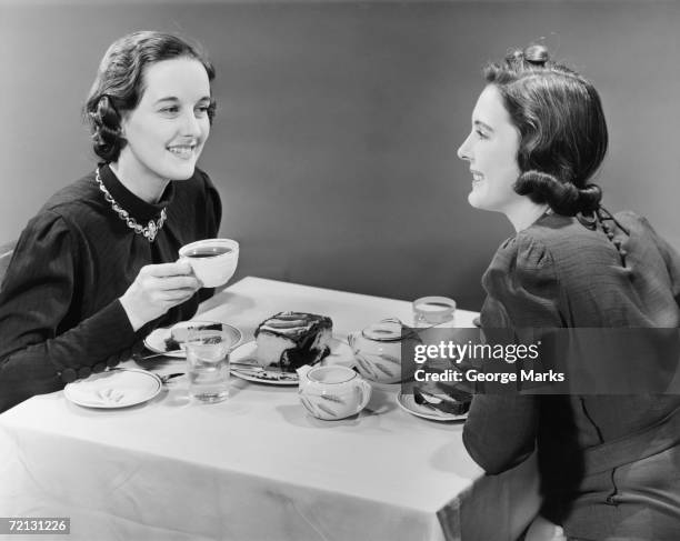 two women having coffee and cake (b&w) - vintage food and drink stock pictures, royalty-free photos & images