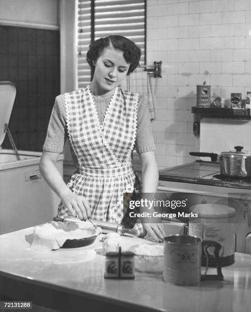woman in kitchen making pie (b&w) - unfashionable woman stock pictures, royalty-free photos & images